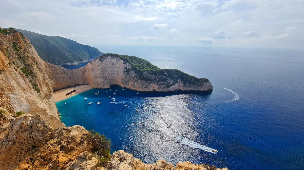 Navagio Shipwreck Beach from above — MV Panagiotis wreck on white pebbles surrounded by turquoise water and limestone cliffs, Zakynthos
